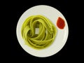 Green noodles on a plate with tomato sauce- isolated Royalty Free Stock Photo