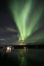 Green northern lights in Lofoten islands, Norway. Aurora borealis. Starry sky with polar lights. Night landscape aurora, sea Royalty Free Stock Photo