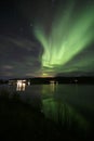 Green northern lights in Lofoten islands, Norway. Aurora borealis. Starry sky with polar lights. Night landscape aurora, sea Royalty Free Stock Photo