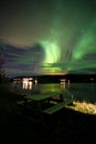 Green northern lights in Lofoten islands, Norway. Aurora borealis. Starry sky with polar lights. Night landscape aurora, sea Royalty Free Stock Photo