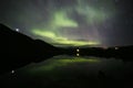 Green northern lights in Lofoten islands, Norway. Aurora borealis. Starry sky with polar lights. Night landscape aurora, sea Royalty Free Stock Photo