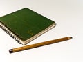 Green Note Book and Pencil