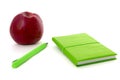 Green notebook and apple isolated white Royalty Free Stock Photo