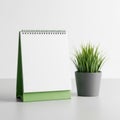 Green notepad and plant isolated on white background Royalty Free Stock Photo