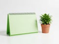 Green notepad and potted plant isolated on white background Royalty Free Stock Photo