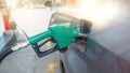 Green nozzle pump Gun petrol from oil pump in the car tank to refueling