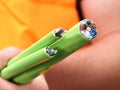 Green Nylon jacketed fiber optic cables bundle hand held Royalty Free Stock Photo
