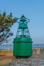 Green ocean buoy on display in maritime park