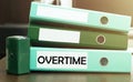 3 green office folders with text Overtime Royalty Free Stock Photo