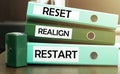 3 green office folders with text Reset Realign Restart Royalty Free Stock Photo