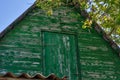 Green old attic on the roof. The roof of the old house against the blue sky Royalty Free Stock Photo