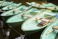 Green old empty boats with wooden oars on the lake closeup. Boat rental Royalty Free Stock Photo