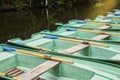 Green old empty boats with wooden oars on the lake closeup.Boat rental Royalty Free Stock Photo