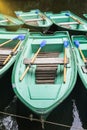 Green old empty boats with wooden oars on the lake closeup Royalty Free Stock Photo