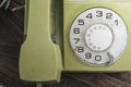 Green old-fashioned telephone on wooden background Royalty Free Stock Photo