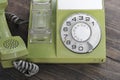 Green old-fashioned telephone on wooden background Royalty Free Stock Photo