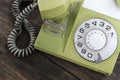 Green old-fashioned telephone on wooden background Royalty Free Stock Photo