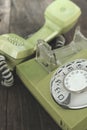 Green old-fashioned telephone on wooden background Royalty Free Stock Photo