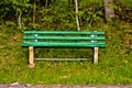 Green old lonely park bench in nature Royalty Free Stock Photo