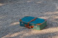 Green old suitcase on grass. Royalty Free Stock Photo