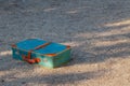 Green old suitcase on grass. Royalty Free Stock Photo