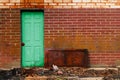 Green old vintage door steel red brick alley wall rusty debris warehouse factory shipping receiving back door employee entrance