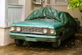 Green Oldtimer Protected From the Rain and Foliage