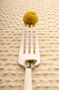 Green olive on a fork , macro shot Royalty Free Stock Photo