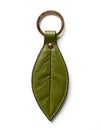 Green olive leather leaf shaped keychain on white background Royalty Free Stock Photo