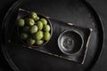 Green olives in a ceramic bowl on a wooden background. Royalty Free Stock Photo