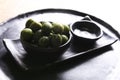 Green olives in a ceramic bowl on a wooden background. Royalty Free Stock Photo