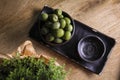 Green olives in a ceramic bowl on a wooden background. Royalty Free Stock Photo