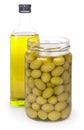 Green olives preserved in bank and a bottle of Royalty Free Stock Photo