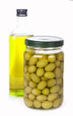 Green olives preserved in bank and a bottle of Royalty Free Stock Photo