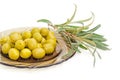 Green olives on saucer and olive branch closeup