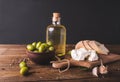 Green olives, sliced ciabatta, feta cheese on a wooden board. Olive oil in a glass bottle. Royalty Free Stock Photo