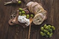 Green olives, sliced ciabatta, feta cheese on a wooden board. Spice. Garlic. Chees Feta. Ciabatta. Olives on a wooden background.