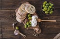 Green olives, sliced ciabatta, feta cheese on a wooden board. Spice. Garlic. Chees Feta. Ciabatta. Olives on a wooden background.