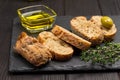 Green olives and slices of bread. Olive oil in glass jar and thyme sprigs Royalty Free Stock Photo