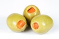 Green olives stuffed with red paprika isolated on white. Royalty Free Stock Photo