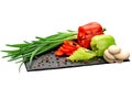 green onions, mushrooms and two fresh red and green bell peppers, cut into rings on a black board made of natural slate Royalty Free Stock Photo