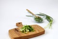 Green onions on a wooden cutting board on the background of kitchen utensils, close-up, space for text Royalty Free Stock Photo