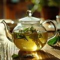 Green oolong tea with herbs in glass on wooden table background. Healthy drink concept. Side view, close up, selective