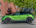 Green Opel Mokka electric car on a parking lot.. Royalty Free Stock Photo