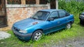 Blue Opel optima or Opel astra F sedan parked on the side of the road Royalty Free Stock Photo