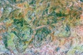 Green, orange, blue and yellow sedimentary rocks - colourful rock layers formed through cementation and deposition - abstract Royalty Free Stock Photo