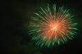 Green and orange fireworks against the backdrop of the night sky Royalty Free Stock Photo