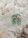 Green Orange Flipflops on a sandy Royalty Free Stock Photo