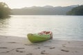 Green and orange kayak on sand beach Royalty Free Stock Photo