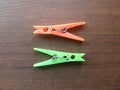 2 green and orange plastic Clothespins Royalty Free Stock Photo